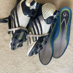 Two pairs of football boots, Adidas, and Nike